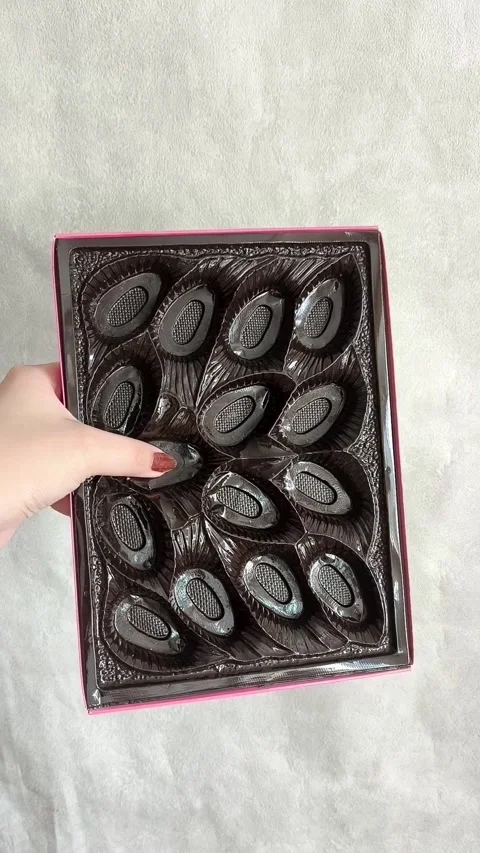 A woman collects packaging for sweets. Empty Chocolate Candy Box Stock-Footage 332409983