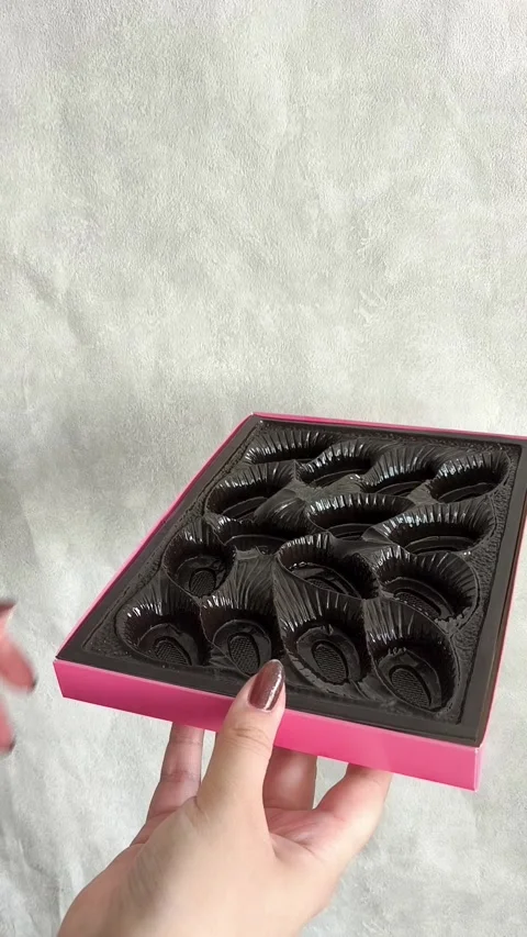 A woman collects packaging for sweets. Empty Chocolate Candy Box Video stock 332409985