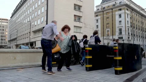A woman collides with a man in the Queue to see The Queen lying in state Stock Footage 212985980