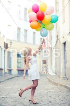 Woman with colorful balloons Stock Photos