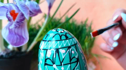 Woman is coloring easter egg Stock Footage 103848445