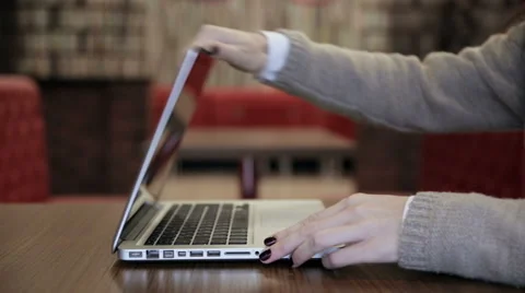 Woman comes, opens the laptop and starts working Stock Footage