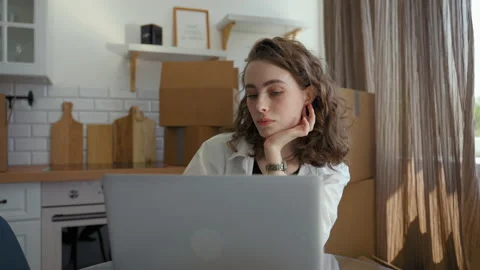 Woman completes task for work via laptop sitting at table Video stock 201167520