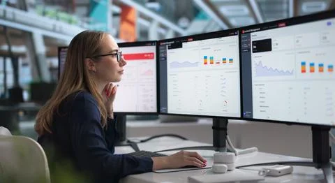 Woman At Computer Actively Tracking IT Incidents For Quick Real-time Resoluti Stock Photos