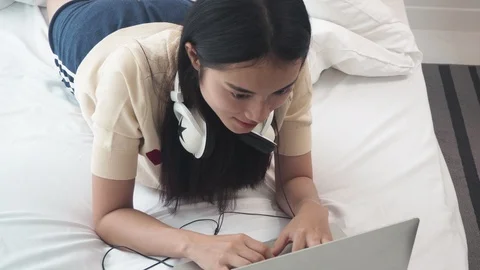 Woman with computer in the bed doing work on laptop Stock Footage 108497477