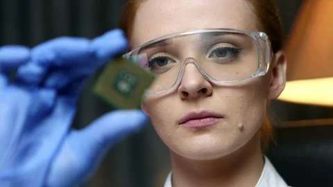 Woman computer IT engineer is holding CPU computer microchip for examination. Stock Footage 103462283