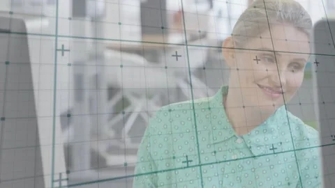 Woman at computer studying pages page flip causing faint grid rotation and shift Stock Footage 331125157