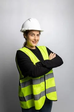 Woman construction engineer worker wearing safety vest and hard hat Stock Photos