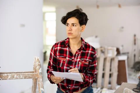 Woman construction manager checking project documentation Stock-Fotos
