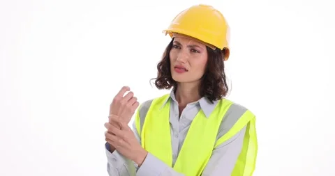 Woman construction worker bends wrist and feels sharp pain Stock Footage 318314775