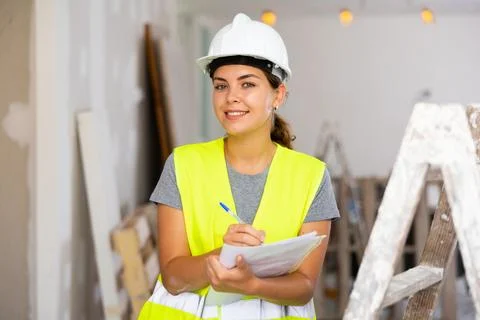 Woman construction worker with project documentation Stock Photos