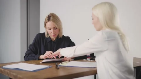 Woman consultant explaining to the client the terms of the contract, signing Stock Footage 219206066
