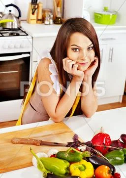 Woman cooking breakfast at kitchen. Stock Photos