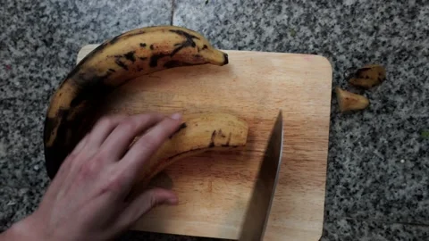 Woman Cooking Peeling a Plantain With a Knife, Closeup Shot Stock Footage