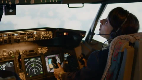 Woman copilot using control panel command in captain cabin Stock Footage 195291074