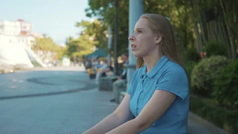Woman Coping with Panic Attack in Public Park. Person struggling to cope with Stock Footage 277571619