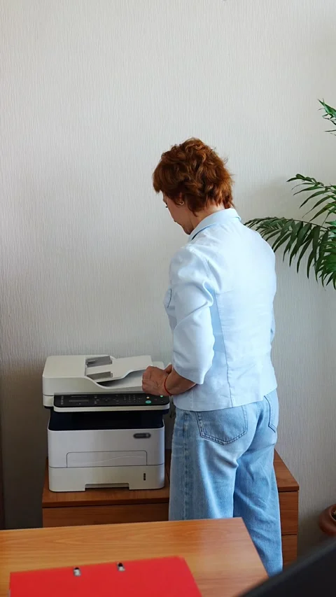 Woman copying documents using an office printer in a realistic administrative Stock Footage 316694797