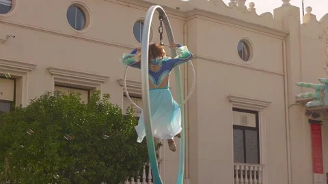 Woman in costume performing acrobatics in a loop at carnival Stock Footage 331983135