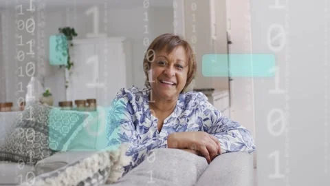 Woman on couch smiling, laughing as binary graphics moving, leaning hands Video stock 333078127