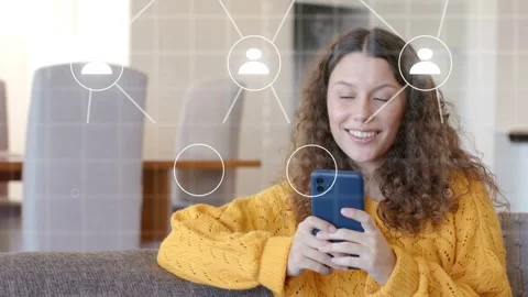 Woman on couch tapping phone, causing node and lines network overlay, Stock Footage 333602419