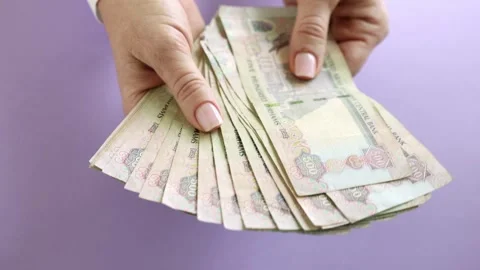 Woman counting AED dirhams in hands, closeup Video stock 249073312