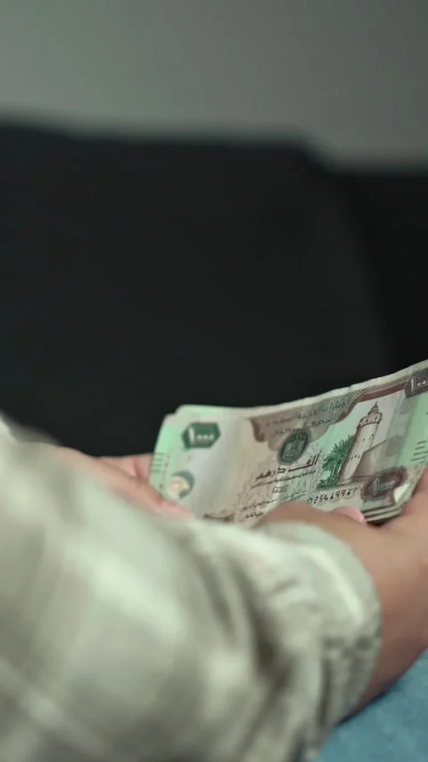 Woman Counting AED Dirhams in hands, closeup. Video stock 286757413