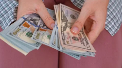 Woman counting a large stack of us dollar bills Stock Footage 331202550