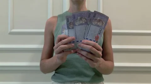 Woman counting Malaysian Ringgit banknotes indoors, finance and economy concept Stock Footage 317503713