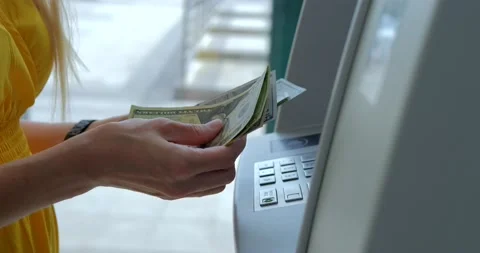 Woman counting us dollars near ATM machine Stock Footage