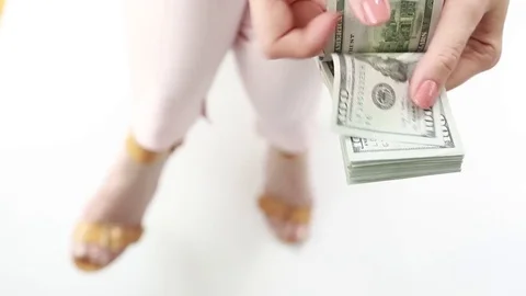A woman counts a pack of dollars.  Stock Footage 76581825