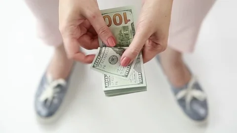 A woman counts a pack of dollars.  Stock Footage 76581916
