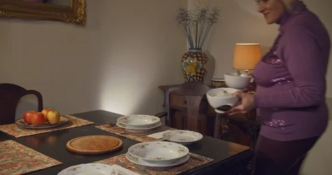 Woman covers table for elegant dinner Stock Footage 102907891