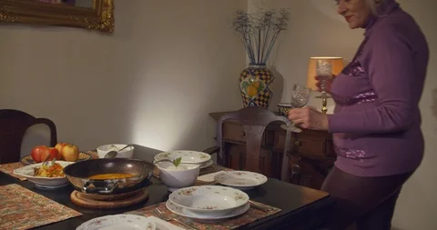 Woman covers table for elegant dinner Stock Footage 102912002