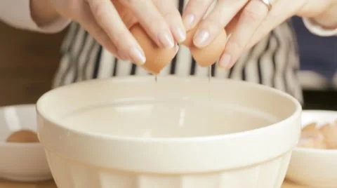 Woman cracking egg Stock Footage 10921515