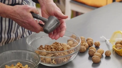 Woman cracking walnuts with a nut cracker Stock Footage 84177150