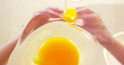 Woman Cracks a Second Egg into a Pan in 4K Stock Footage 65446323