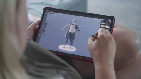 Woman creates 3D model using tablet computer and digital pen Stock Photos