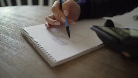 Woman creates a project, plan of apartment renovation on paper Stock Footage 139629490