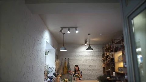 Woman creating flower compositions in workshop Stock Footage 122952773