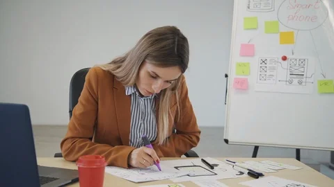 Woman creating new prototype for mobile application on paper Stock Footage 115659050