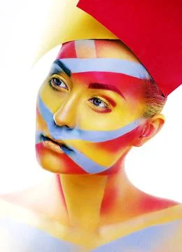 Woman with creative geometry make up, red, yellow, blue closeup smiling colored Stock Photos
