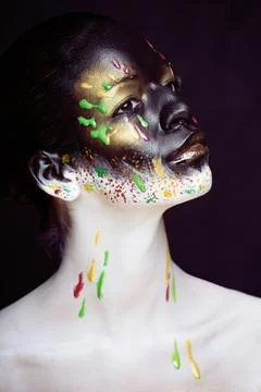 Woman with creative makeup closeup like drops of colors, facepaint close up Stock Photos