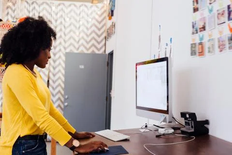 Woman in creative studio using computer 스톡 사진