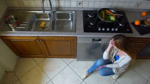 Woman is crying in the kitchen. Top view Stock Footage 73751239