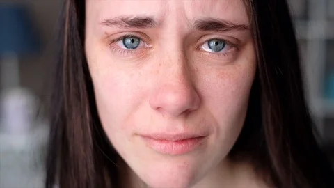 Woman crying looking at the camera Stock Footage