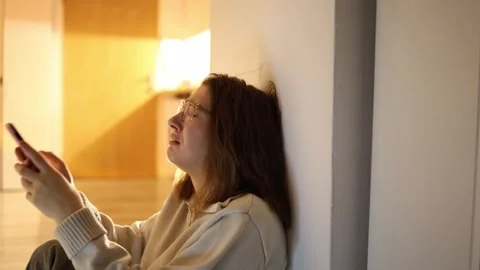 Woman crying over breakup looking at phone Video stock 334057744
