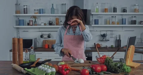 Woman crying while cutting onion in kitchen Stock Footage 139455536