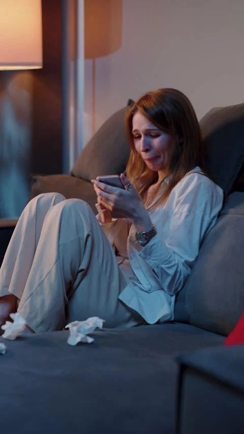 Woman crying while reading message on phone Vídeos de archivo 323186713