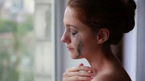 Woman crying at the window Stock Footage