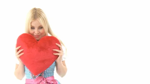 Woman cuddling with heart pillow Stock Footage